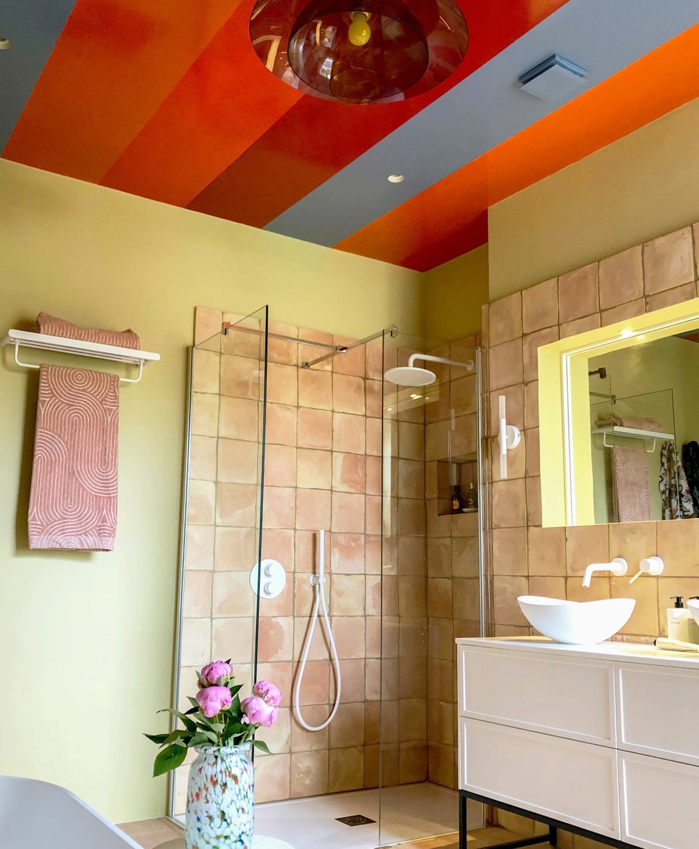 Modern bathroom with colourful ceiling painted in Mylands paints, shower, and vanity area.