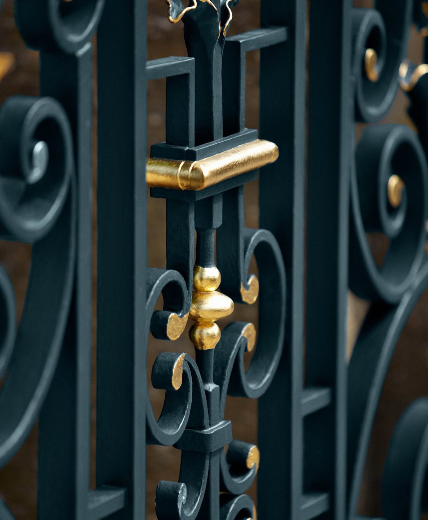 Decorative wrought iron gate with gold accents