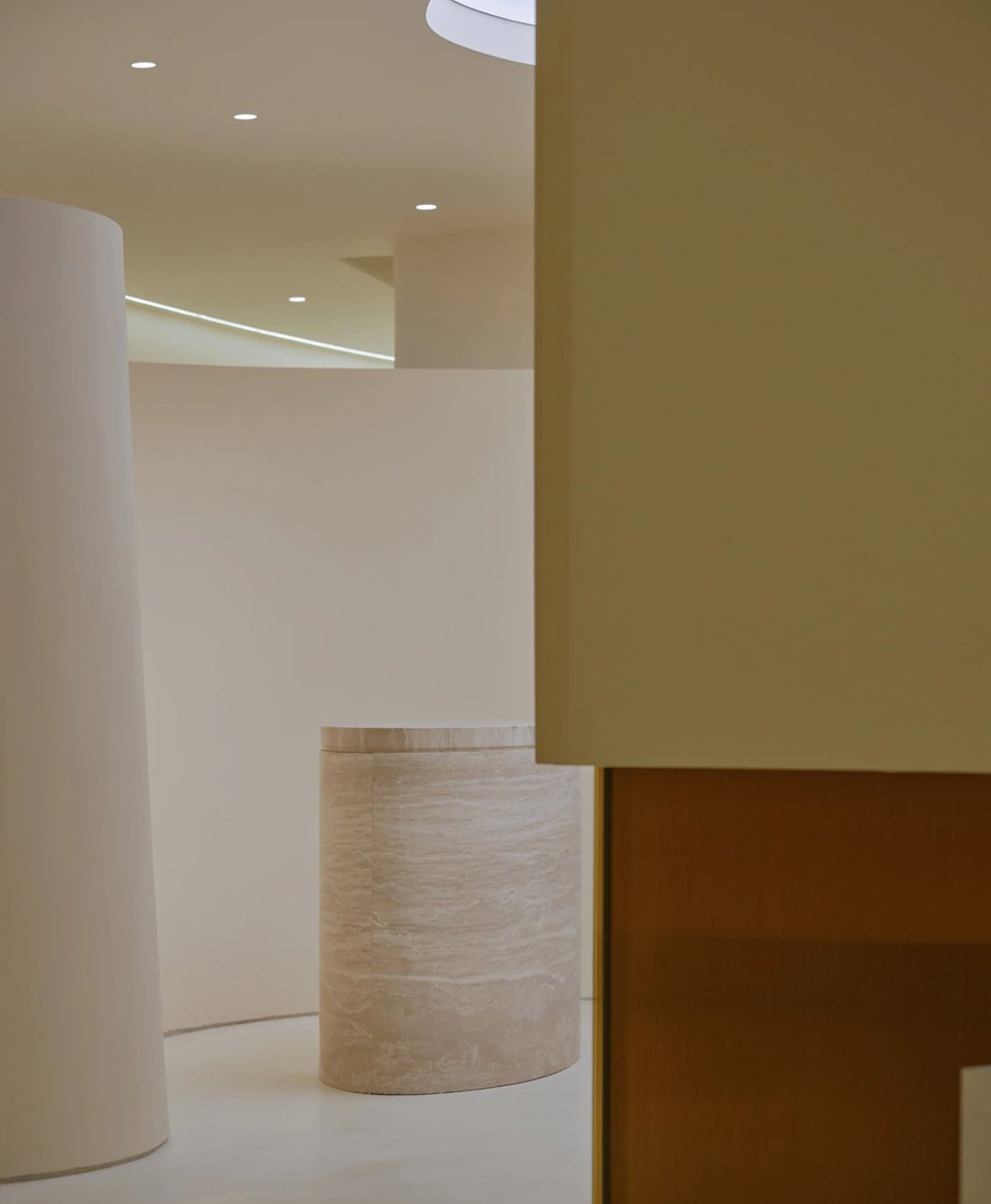 Modern interior design with cylindrical beige columns and a neutral color palette.