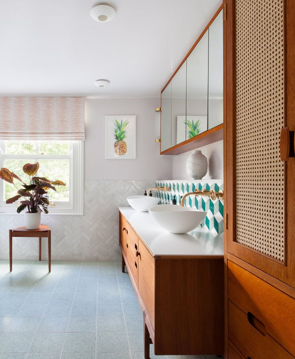 Off-white bathroom with wooden vanity, white countertop, and decorative elements.