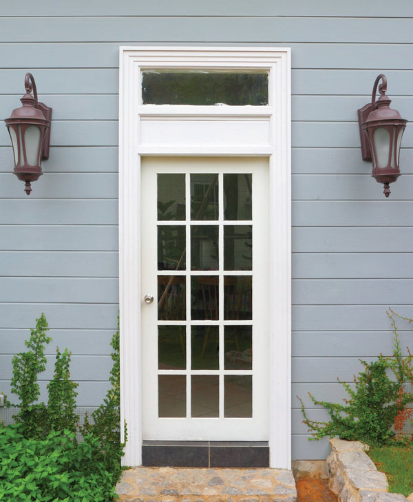 White door with glass panels on a blue grey house exterior