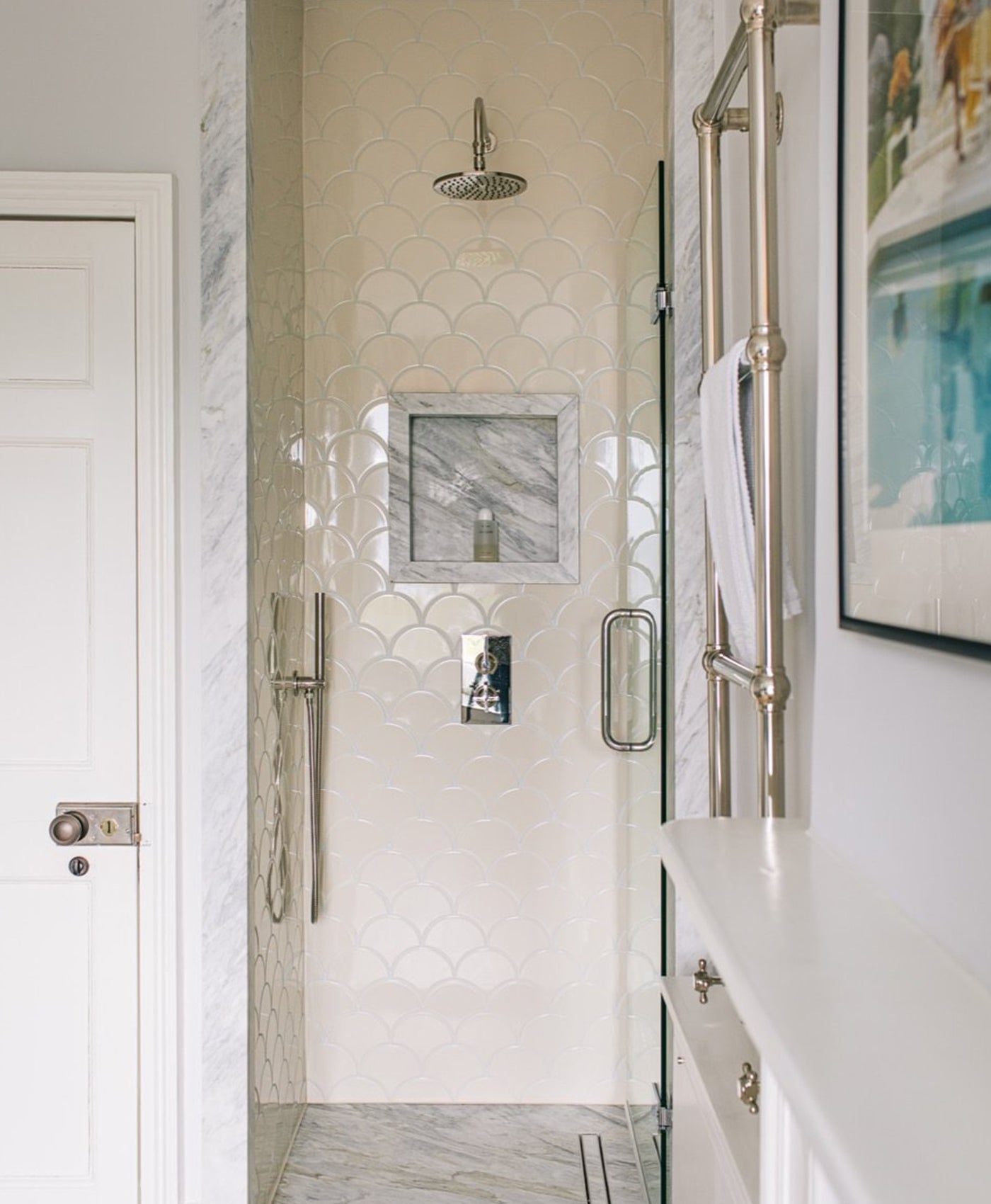 Bathroom with shower enclosure, mirror, and decorative elements.