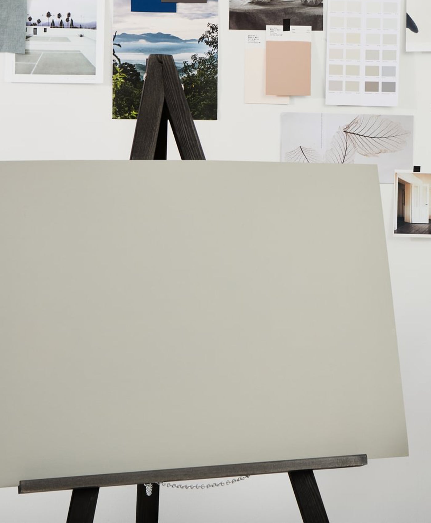 grey painted  canvas on an easel with colour swatches in the background