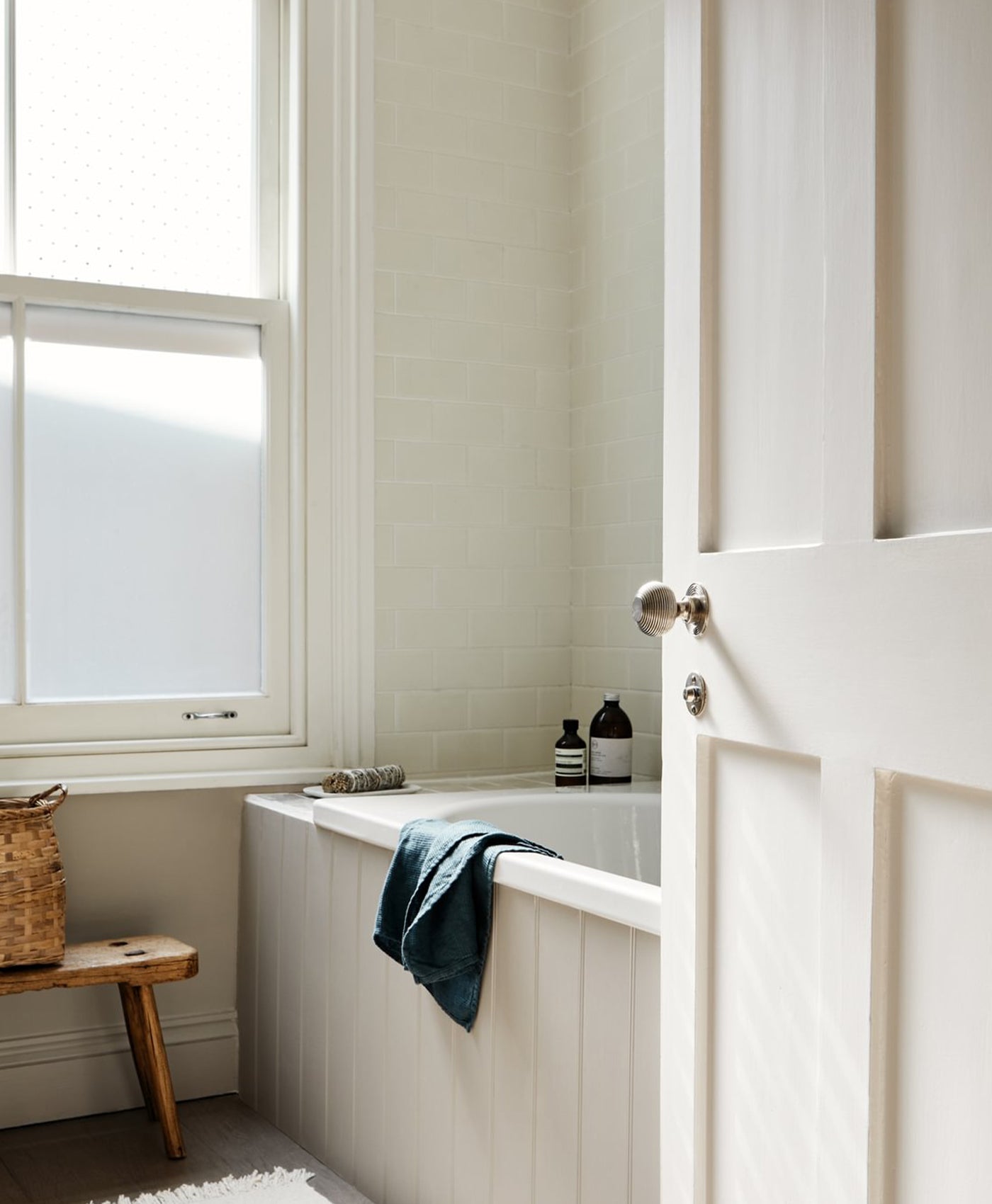 Bathroom with a bathtub, towel, and window