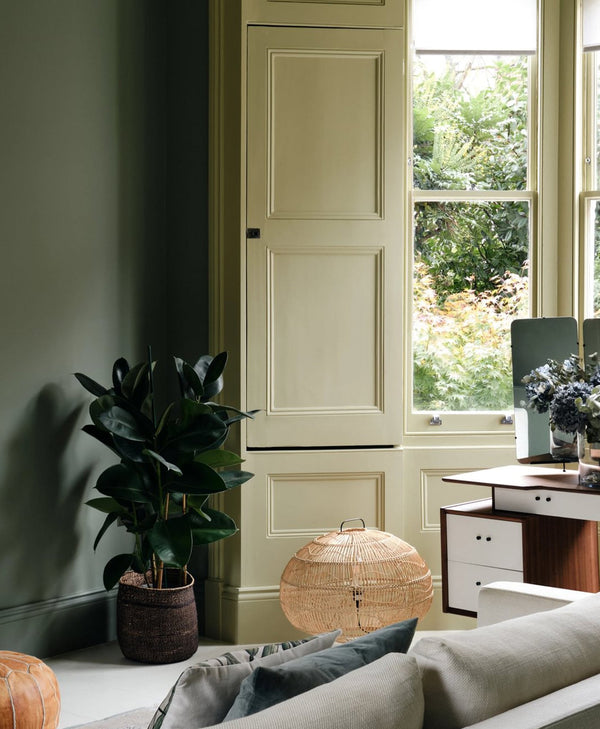 olive green Living room with a sofa, lamp, and large window