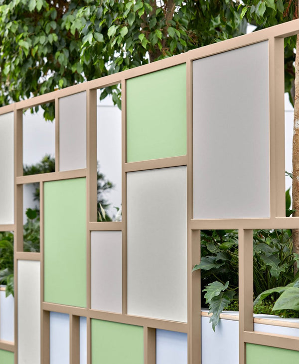 Decorative screen with geometric pattern in a garden setting