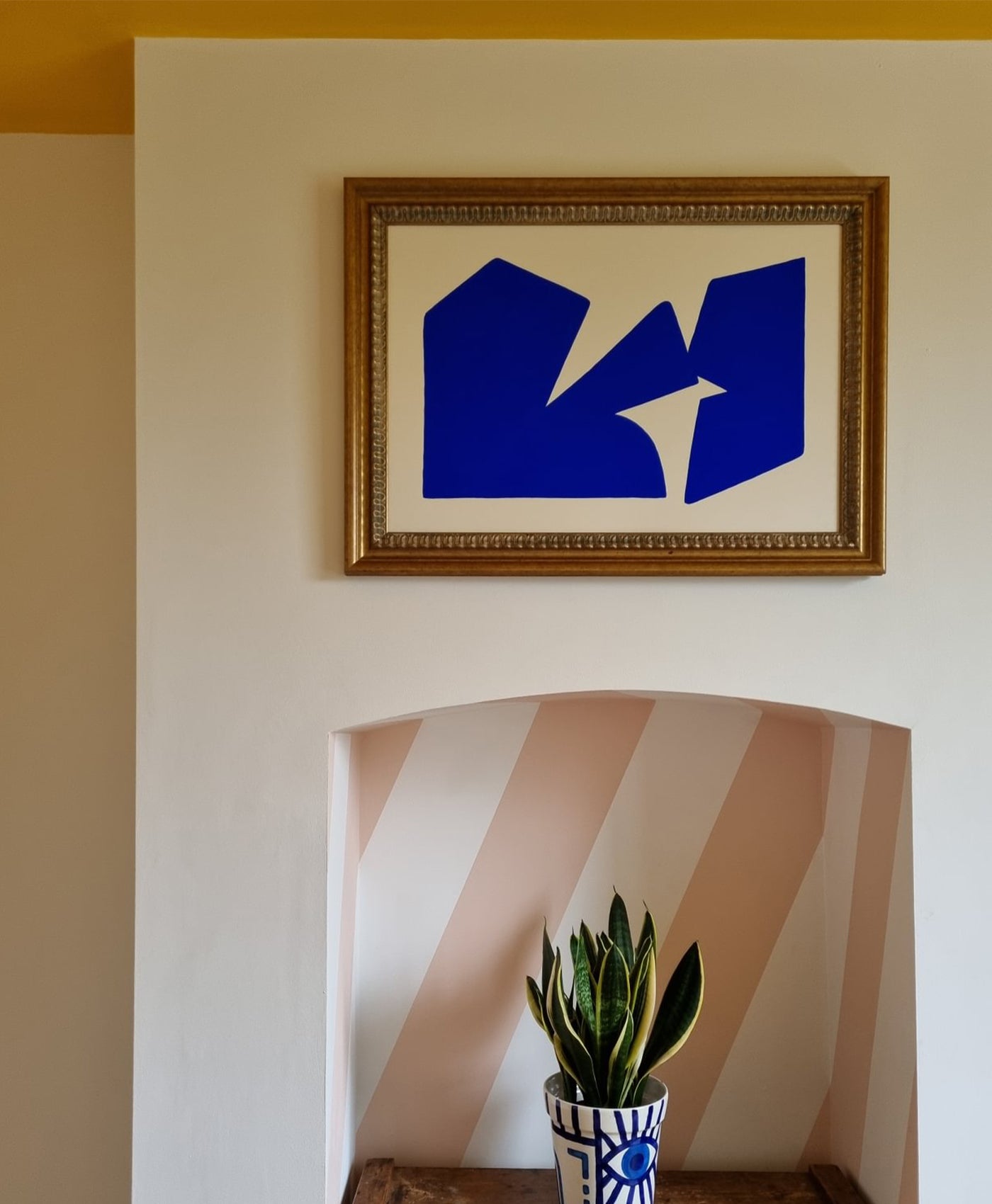 white walls with pale pink stripes in fire surround and yellow paint on ceiling