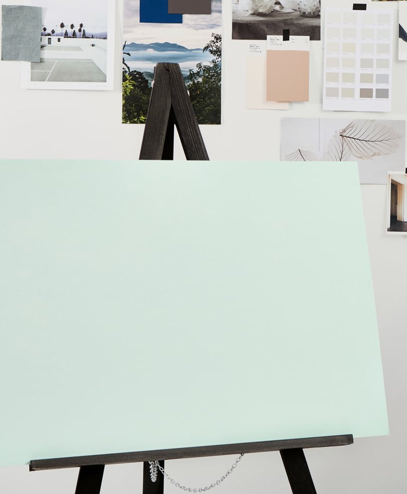 Blank canvas on an easel with color swatches in the background