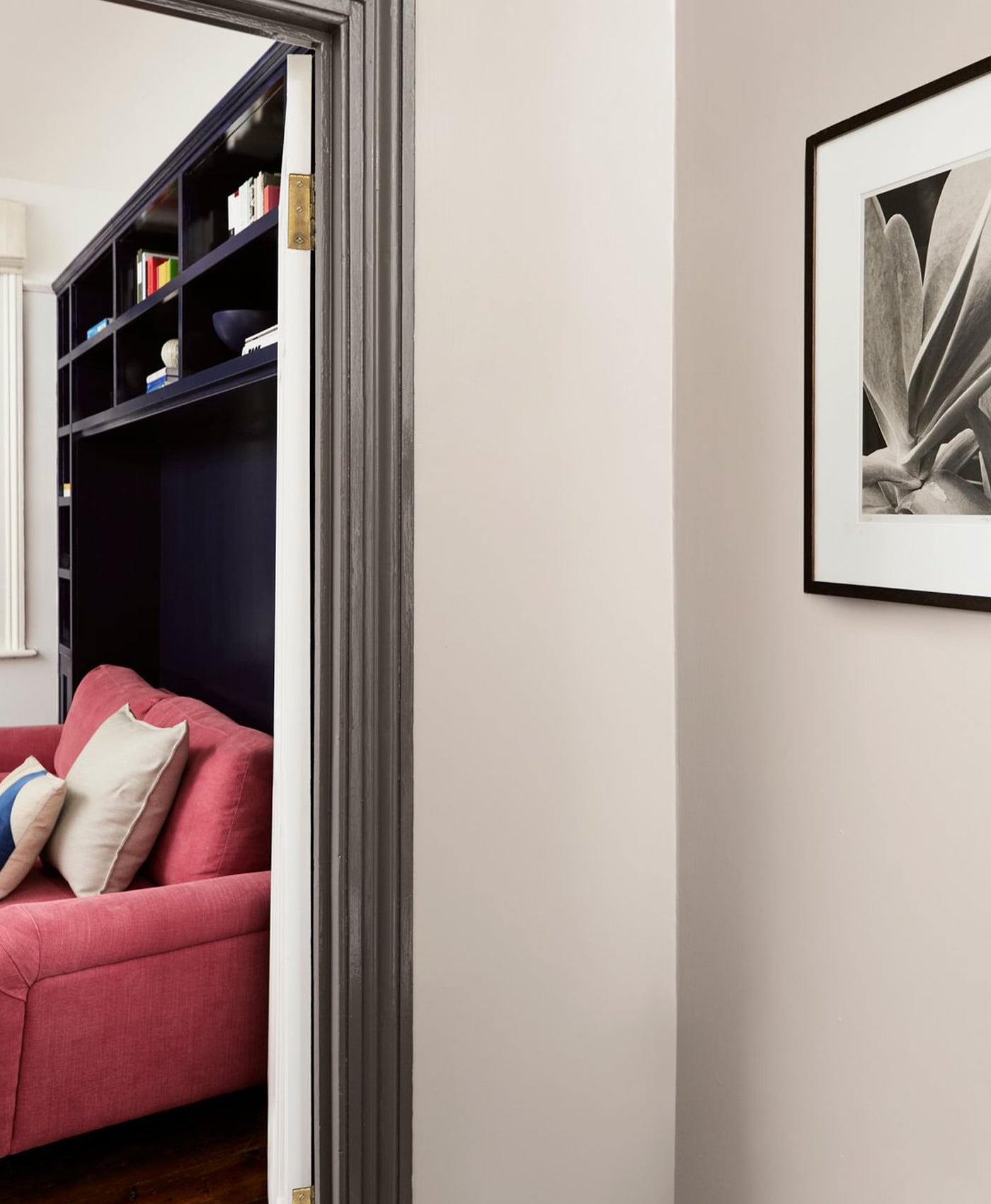 pale neutral room with grey brown trim colour on door frame