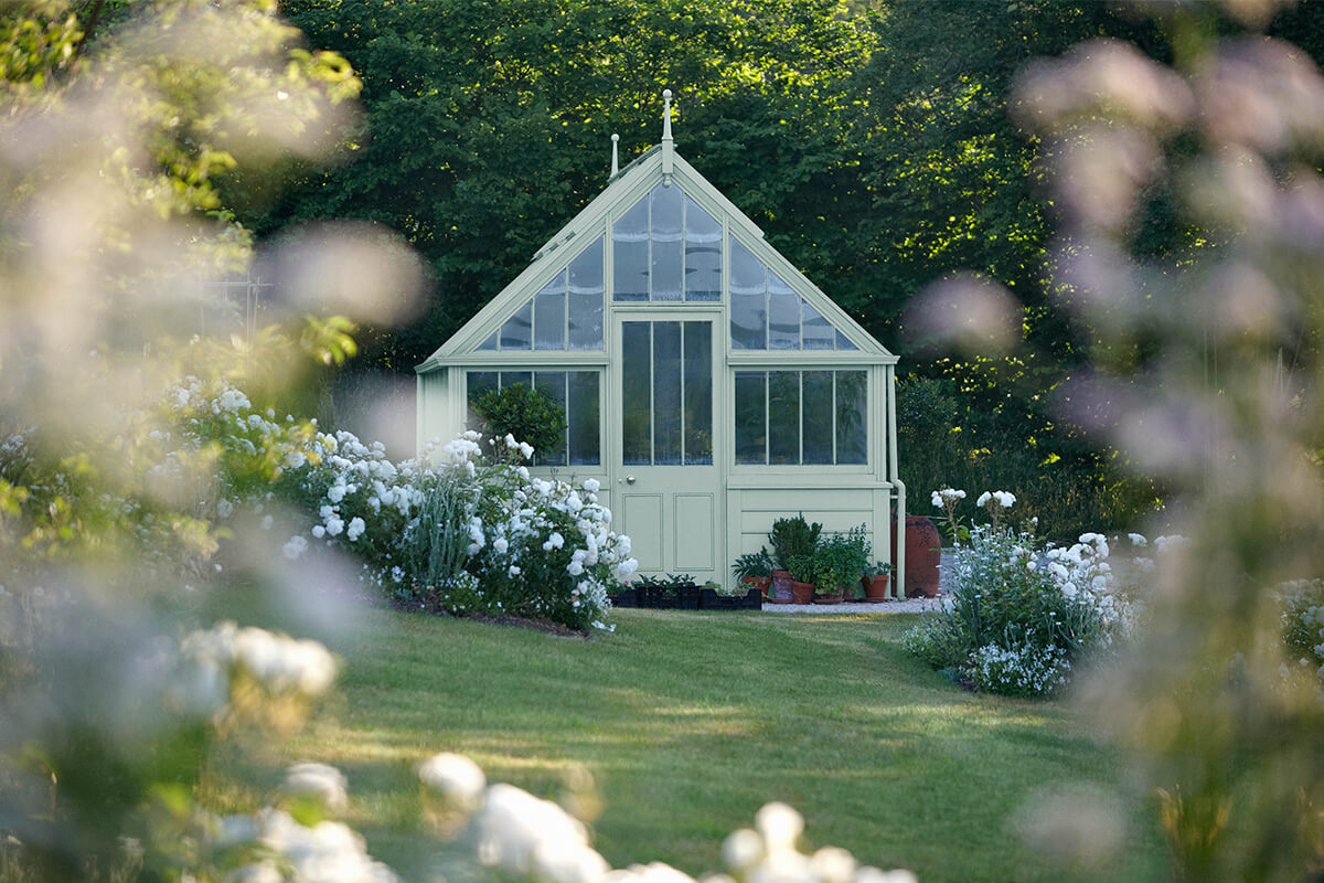 A wooden summer house painted with Grail JB02 coloured paint